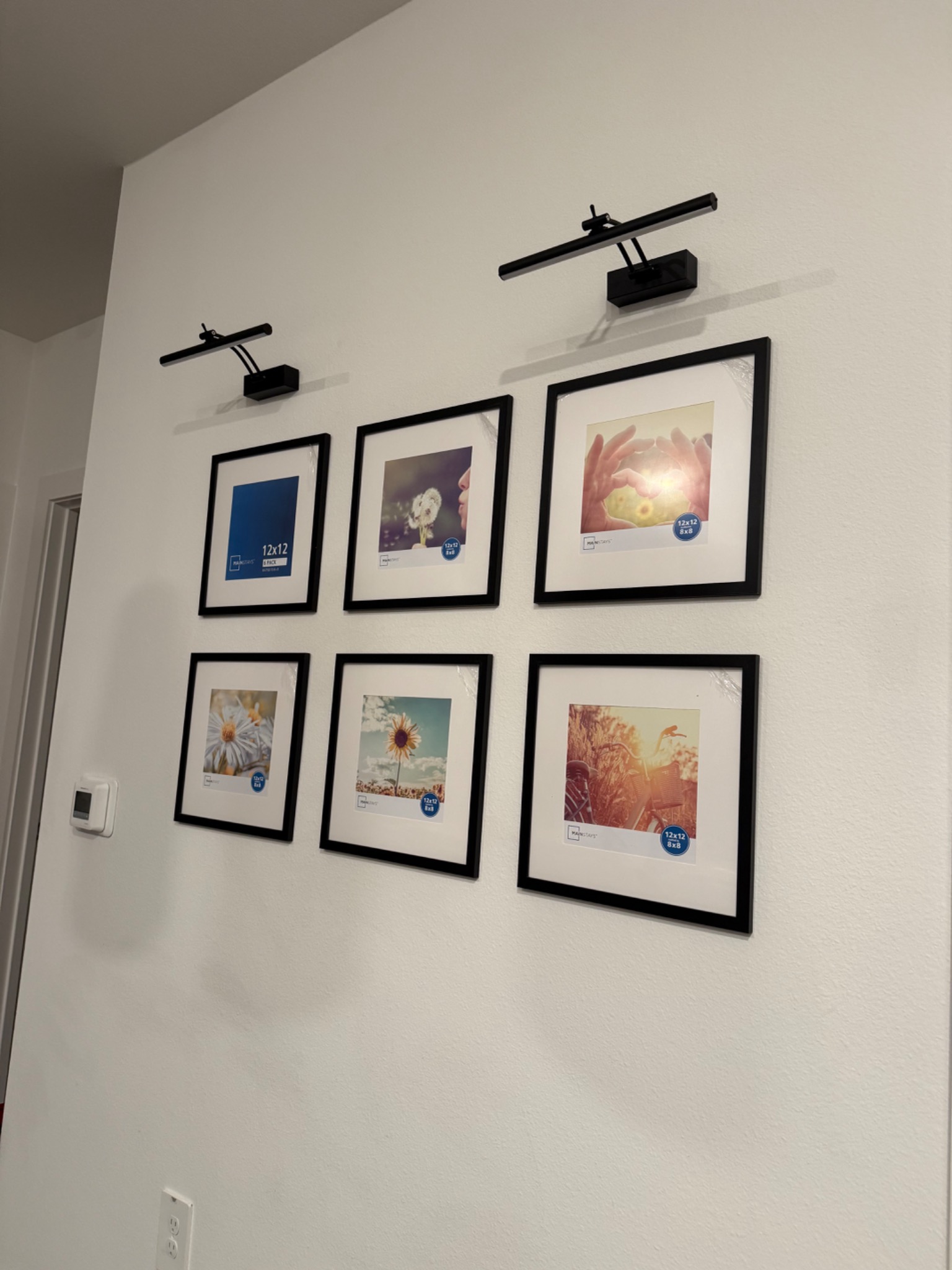 Gallery wall of picture frames with lights