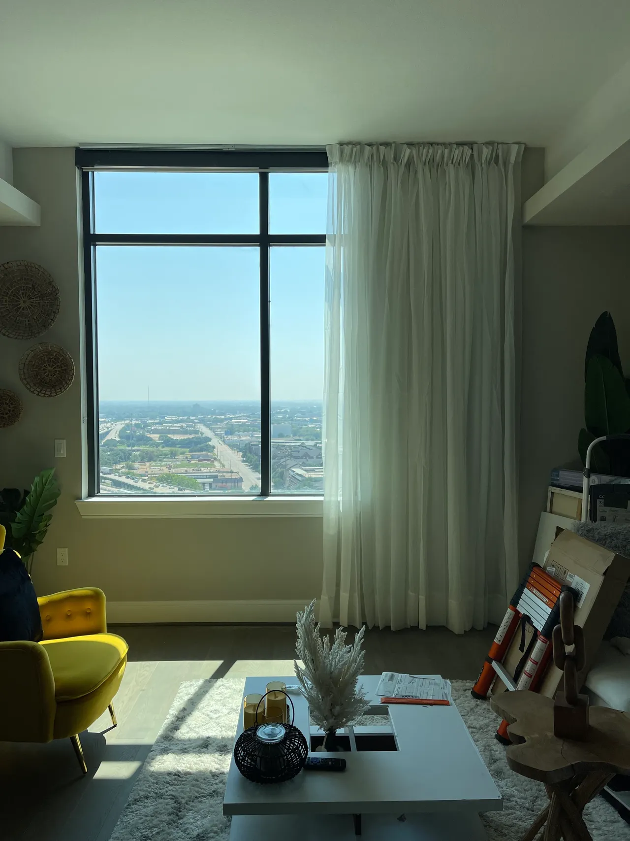 Living room with floor-to-ceiling window and curtains